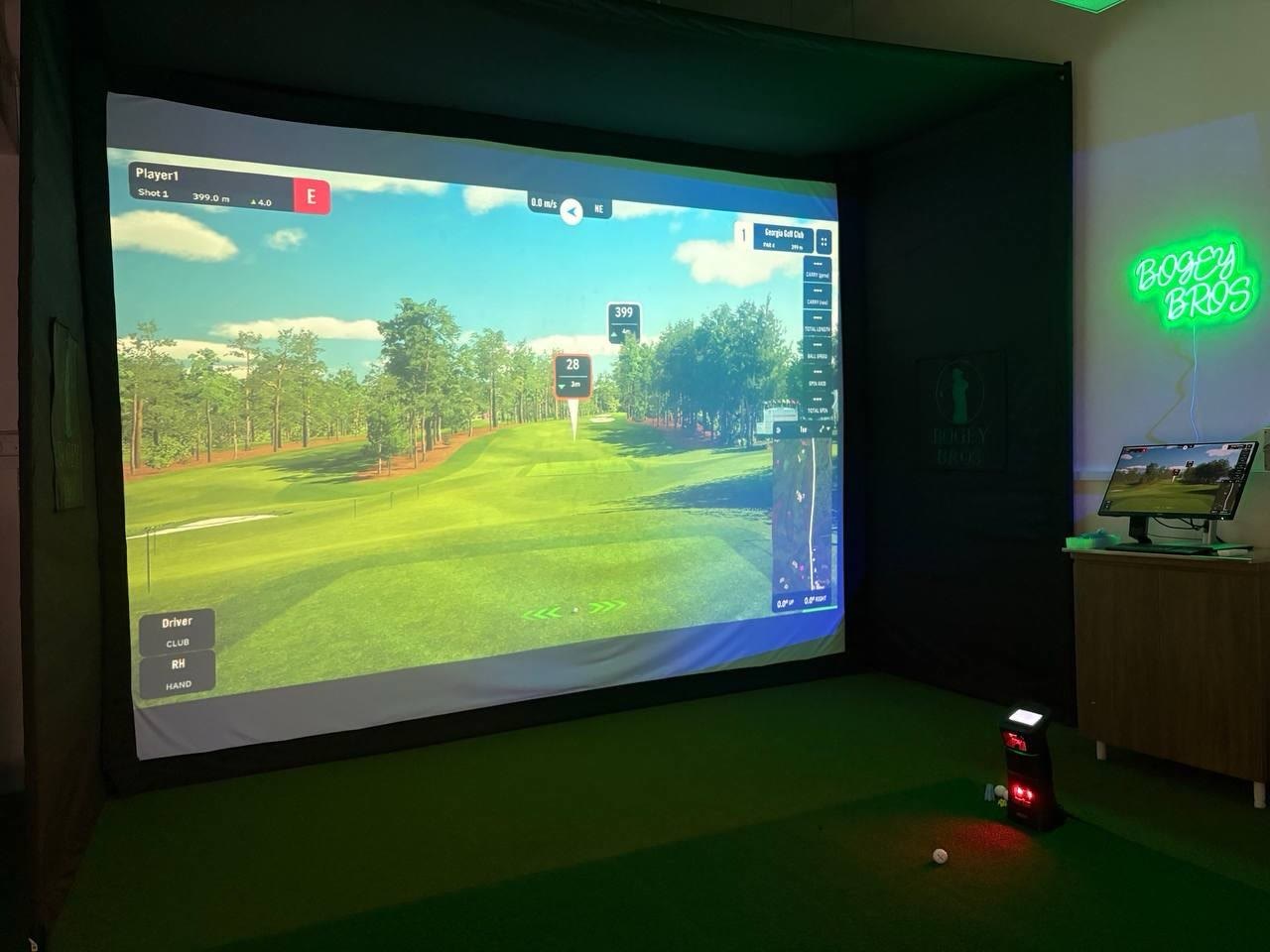 Private golf simulator bay in Singapore with GSPro projected on a wall-sized screen at Bogey Bros NEWest