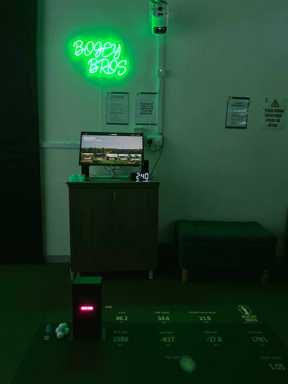 Neon-lit private simulator station at Bogey Bros golf simulator Singapore